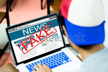stock-photo-fake-news-hoax-concept-young-man-using-laptop-or-computers-551220664